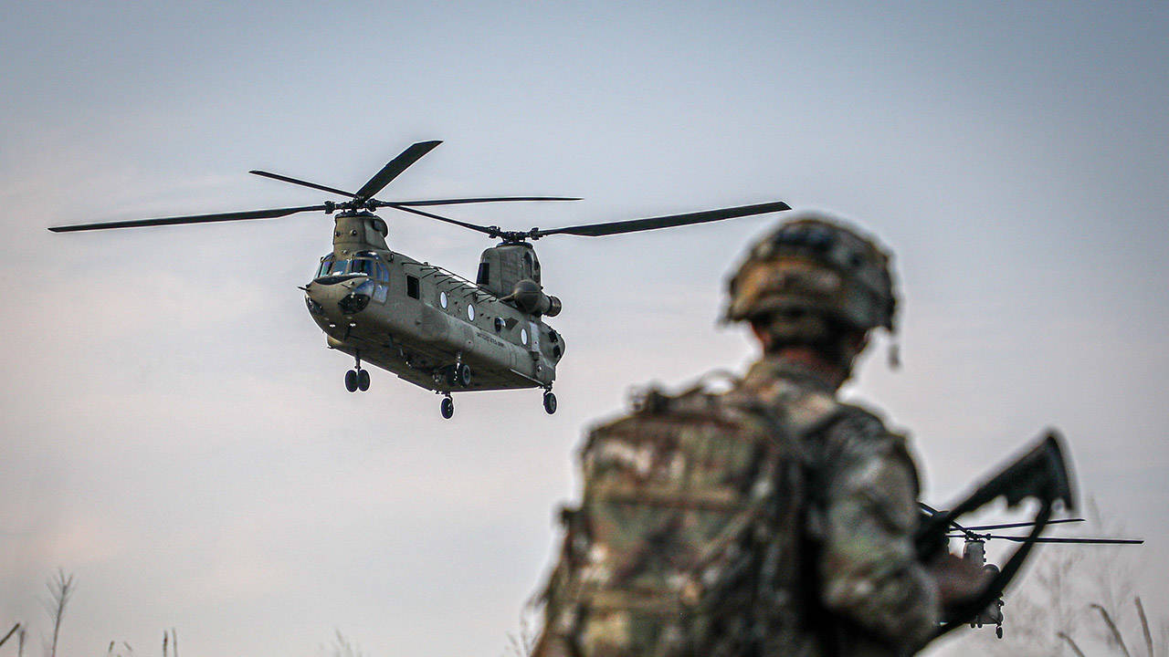 Army Paratrooper Watches CH-47 Chinook Helicopter
